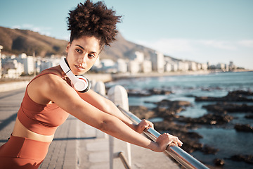 Image showing Black woman, fitness rest and music on beach for exercise training, cardio wellness and workout outdoor. African girl, thinking and relax mindset or runner break with radio for health by ocean sea