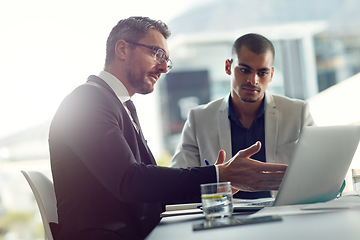 Image showing Business people, laptop and talking about planning online for corporate strategy or partnership. Men together in a meeting discussion while speaking about internet report, email or communication