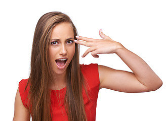 Image showing Wow, hand and portrait of a woman with gun for shooting isolated on a white background in studio. Surprise, violence and girl with dark humor, finger rifle to shoot and pointing to head on a backdrop