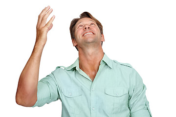 Image showing Thank you, happy and man in studio, smile and celebrating victory while looking up on white background. Hand, success and young male in prayer for successful, winner or achievement while isolated