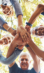 Image showing Senior hands, together and support with solidarity outdoor and group diversity with team building in nature. Trust, respect and mission, mature community and hand stack low angle with collaboration.