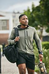 Image showing Exercise, black man and walking with water bottle, for training and workout for wellness, fitness and health. African American male, athlete or bodybuilder ready for practice, motivation or hydration