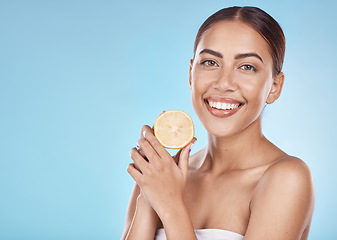 Image showing Wellness, facial and lemon portrait of girl with natural smile and healthy glow for marketing. Beauty, skincare and self care model with fruit for cosmetic advertising in blue studio mockup.