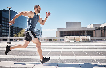 Image showing Fitness, exercise and man running in city for health and wellness. Sports runner, energy and male athlete exercising, cardio jog or training workout outdoors on street for race, marathon or endurance