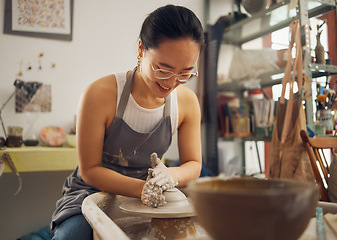 Image showing Clay, sculpture or creative woman in workshop working on an artistic cup or mug mold in small business. Smile, Asian girl or happy Japanese worker manufacturing pottery products as entrepreneur