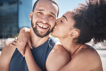 Image showing Couple with fitness, kiss in portrait outdoor and love, exercise in city with motivation and health together. Black woman hug man, sports and training with partnership, commitment and relationship