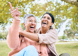 Image showing Senior women, pointing or laughing in nature park, grass garden or relax environment in comic joke or funny meme. Smile, happy or couple of friends in retirement elderly bonding, hug or hand gesture