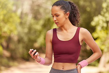 Image showing Fitness, woman and checking stop watch for running exercise, workout or training in the nature outdoors. Active female runner looking at time for monitoring run, steps or cardio performance tracking