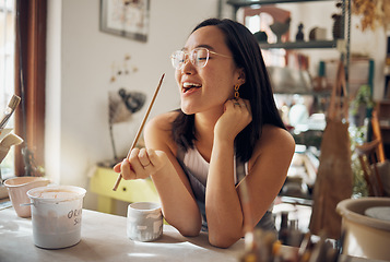 Image showing Happy creative asian woman, art and smile for pottery small business startup in ceramic design. Artistic Japanese female smiling in happiness for arts and crafts holding paint brush for creativity