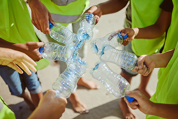 Image showing Hands group, circle and plastic bottles in beach waste management, community service and climate change volunteering. Kids diversity, teamwork and trash cleaning in environment sustainability recycle