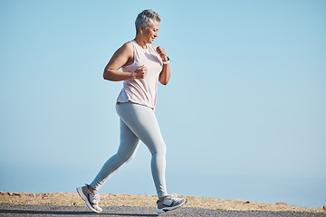 Image showing Sports, nature and senior woman doing a running workout for health, wellness and exercise in Puerto Rico. Fitness, runner and elderly female cardio athlete at outdoor training for a marathon or race.