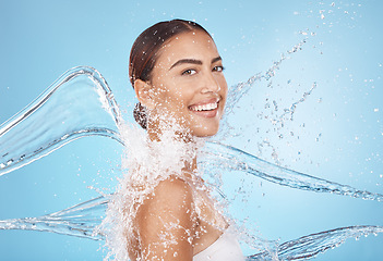 Image showing Happy woman, body skincare or water splash on blue background studio in healthcare wellness, Brazil hygiene maintenance or shower grooming. Smile portrait, beauty model or wet water drop for cleaning