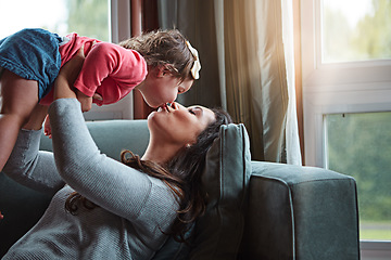 Image showing Relax, happy and kiss with mother and baby on sofa for bonding, quality time and child development. Growth, support and trust with mom and daughter in family home for health, connection and care