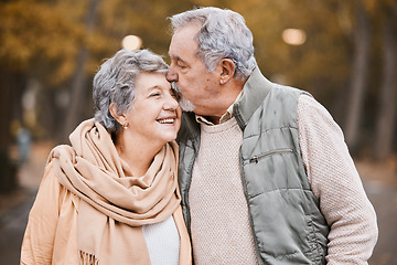 Image showing Love, kiss and senior couple in park enjoying weekend, quality time and romantic bonding together. Retirement, relationship and elderly man and woman walking, hugging and embrace outdoors in nature