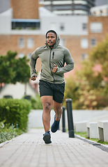 Image showing Fitness, exercise and black man running in city in winter for health, wellness and strength. Sports, thinking and male runner exercising, cardio jog or training outdoors alone on street for marathon.