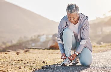 Image showing Lace shoes, fitness and woman on mountains for workout, running and wellness. Mature female tie sneakers for exercise, sports and runner performance for healthy body goals, training and nature hiking