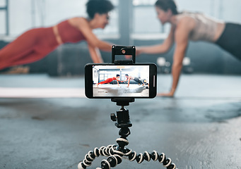 Image showing Influencer, phone and fitness people recording, filming or broadcast online training video, exercise tutorial or guide. Sports, handshake and athlete team, women of friends live streaming gym workout