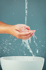 Image showing Woman hands, water splash with sink, washing and skin isolated on studio background, hygiene and skincare with beauty. Liquid, health and wellness with natural cosmetics, body care and shower