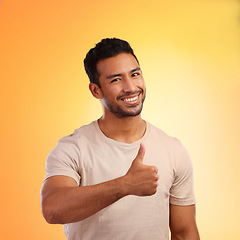 Image showing Hands, thumbs up and portrait of man in studio isolated on a yellow background. Face, fashion and happy male model with hand gesture for like emoji, motivation or success, agreement or thank you.