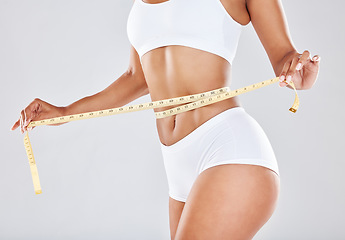 Image showing Health, wellness and woman with measuring tape on waist, healthy diet and exercise for body care. Fitness, nutrition and flat stomach, girl tracking weight loss progress isolated on white background.