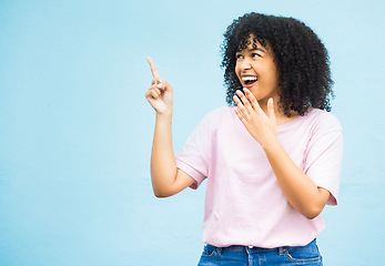 Image showing Mock up, surprise or happy black woman point at sales promo, discount gift deal or marketing space gesture. Wow, product placement mockup or female advertising girl isolated on blue background studio