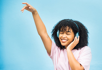Image showing Dance music, studio mock up and black woman listening to song, audio podcast or radio sound for energy, relief or fun. Studio mockup, dancing girl and African girl isolated on blue background wall