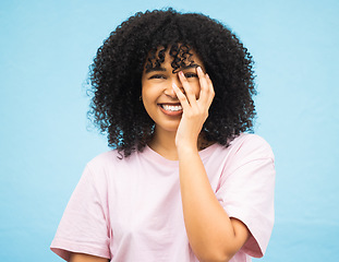 Image showing Hands, smile and portrait of black woman on blue background with makeup, cosmetics and fashion mockup. Beauty, advertising and happy face of girl with copy space for sale, promotion news and discount