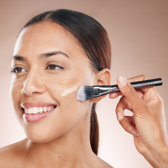 Image showing Beauty, makeup and woman with foundation in a studio for cosmetic skincare routine with a brush. Cosmetics, skin and happy girl model from Mexico with a luxury face tone isolated by brown background.