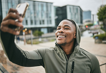 Image showing Phone selfie, fitness and black man in city taking picture for social media or happy memory outdoors in winter. Sports, training and male runner with 5g mobile smartphone taking a photo on street.