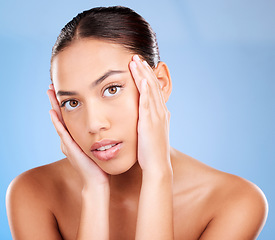 Image showing Portrait, skincare or model in studio after beauty or facial grooming routine on a blue background with mockup space. Luxury, healthy girl or beautiful woman touching face for self love or self care