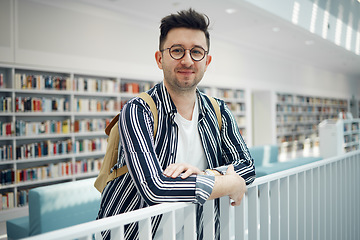 Image showing College, portrait and man student in a bookstore for studying, learning or knowledge with books. Education, library and young male with a college scholarship standing in the academic study area.