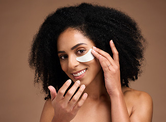 Image showing Face, skincare and black woman with eye patch in studio on a brown background. Portrait, makeup and cosmetics of female model with facial collagen pad or product for anti aging, hydration or wellness