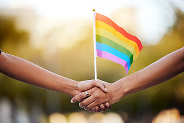 Image showing LGBTQ rainbow, flag and couple holding hands for gay pride, lesbian support or human rights activist. Transgender, love and African black people together for equality, partnership and LGBT community