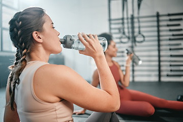 Image showing Fitness, gym and relax friends drinking water for sports thirst hydration, performance workout or exercise running. Athlete health, fatigue and tired women with liquid bottle drink after training