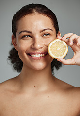 Image showing Skincare, face and woman with lemon in studio isolated on a gray background. Fruit, organic cosmetics and happy female model holding fruits for healthy diet, vitamin c or minerals, wellness or beauty