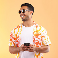 Image showing Sunglasses, phone and man typing in studio isolated on a yellow background. Technology, thinking and happy male model with mobile smartphone for social media, text messaging or internet browsing.