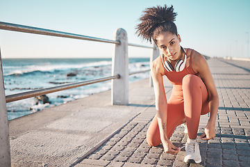 Image showing Portrait, exercise and black woman tie shoes, promenade and fitness for energy, wellness and training. African American female, lady and runner tying sneakers, workout and ready for run and practice