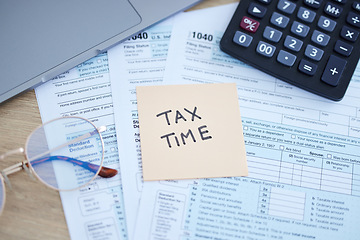 Image showing Tax time, finance accounting and form for government law compliance, file income revenue return or self assessment. Taxation calculator, sticky note and financial audit paperwork for taxes payment