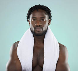 Image showing Black man, skincare and portrait of face with towel for beauty, hygiene and grooming in studio. Healthy person on blue background for facial glow, clean skin and self care with dermatology cosmetic