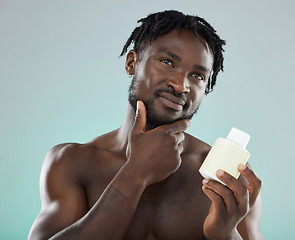 Image showing Skincare, black man and cream for cosmetics, wellness and natural beauty with guy on grey studio background. African American male, confident person and gentleman with lotion for smooth or clear skin