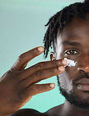 Image showing Black man, hands and face for skincare moisturizer, lotion or cream for facial glow or treatment against studio background. African American male, person or guy applying creme for smooth or soft skin