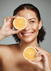 Image showing Woman, smile and orange in studio for skincare, health and wellness with cosmetic glow, self care and backdrop. Model, black woman and fruit for cosmetics, detox or healthy natural skin by background