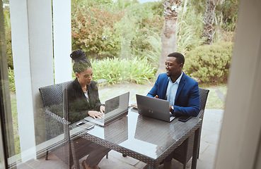 Image showing Business people, man and black woman in meeting on terrace, laptop and finance goal on business trip. Black man, woman and teamwork in morning business meeting on patio, hotel or garden for planning