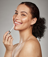 Image showing Woman, lipstick and smile for makeup cosmetics, skincare or beauty against a grey studio background. Portrait of happy female smiling in satisfaction for lip, mouth and applying cosmetic treatment