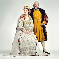 Image showing King, queen and crown with a couple in studio on a gray background during the renaissance or victorian period. Royalty, history and vintage with a man and woman monarch, leader or ruler of a kingdom