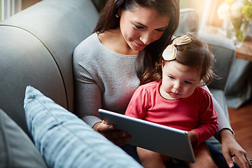 Image showing Mother, baby and tablet on sofa watching educational video online on streaming service in home. Love, family time and woman with girl child smile on couch to watch kids movie or cartoon on website.