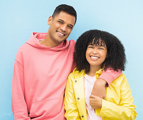 Image showing Happy couple, smile portrait and cool fashion standing in blue background for love, support and care. Black woman, man and happiness hug together for trendy gen z or millenial street style clothes