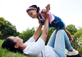 Image showing Black family, park and flying with a mother and daughter having fun together while bonding on grass outdoor. Kids, love and nature with a woman and girl playing in a nature garden outside in summer