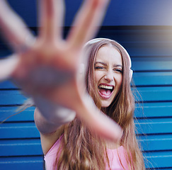 Image showing Music, dance and wink with a woman reaching on a blue background while listening to the radio. Freedom, fun and audio with an attractive young female streaming a playlist or song while dancing