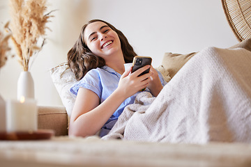 Image showing Phone, sofa and relax woman typing post to social media app, online blog or doing internet web search. Laugh, networking communication and gen z girl reading meme, news or contact social network user